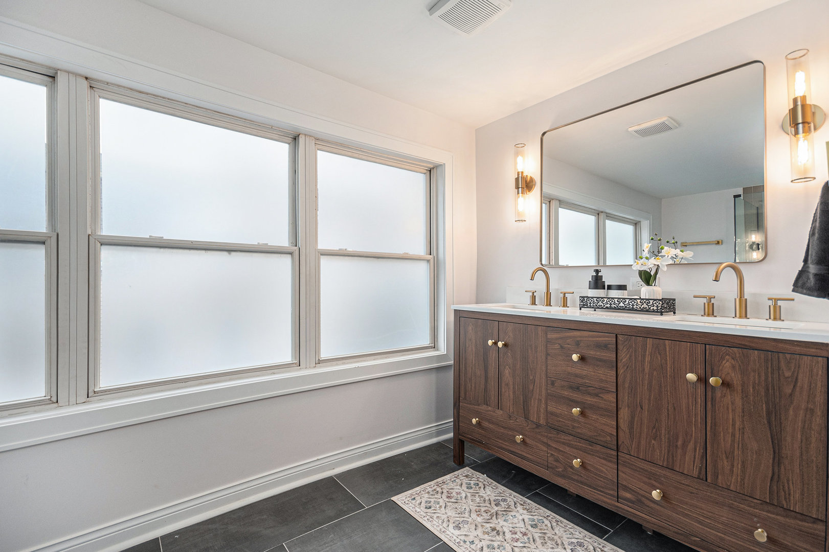 4138 Arthur Avenue Brookfield, IL 60513 - Photo 16 of 25 a bathroom with a double vanity sink a mirror and a window