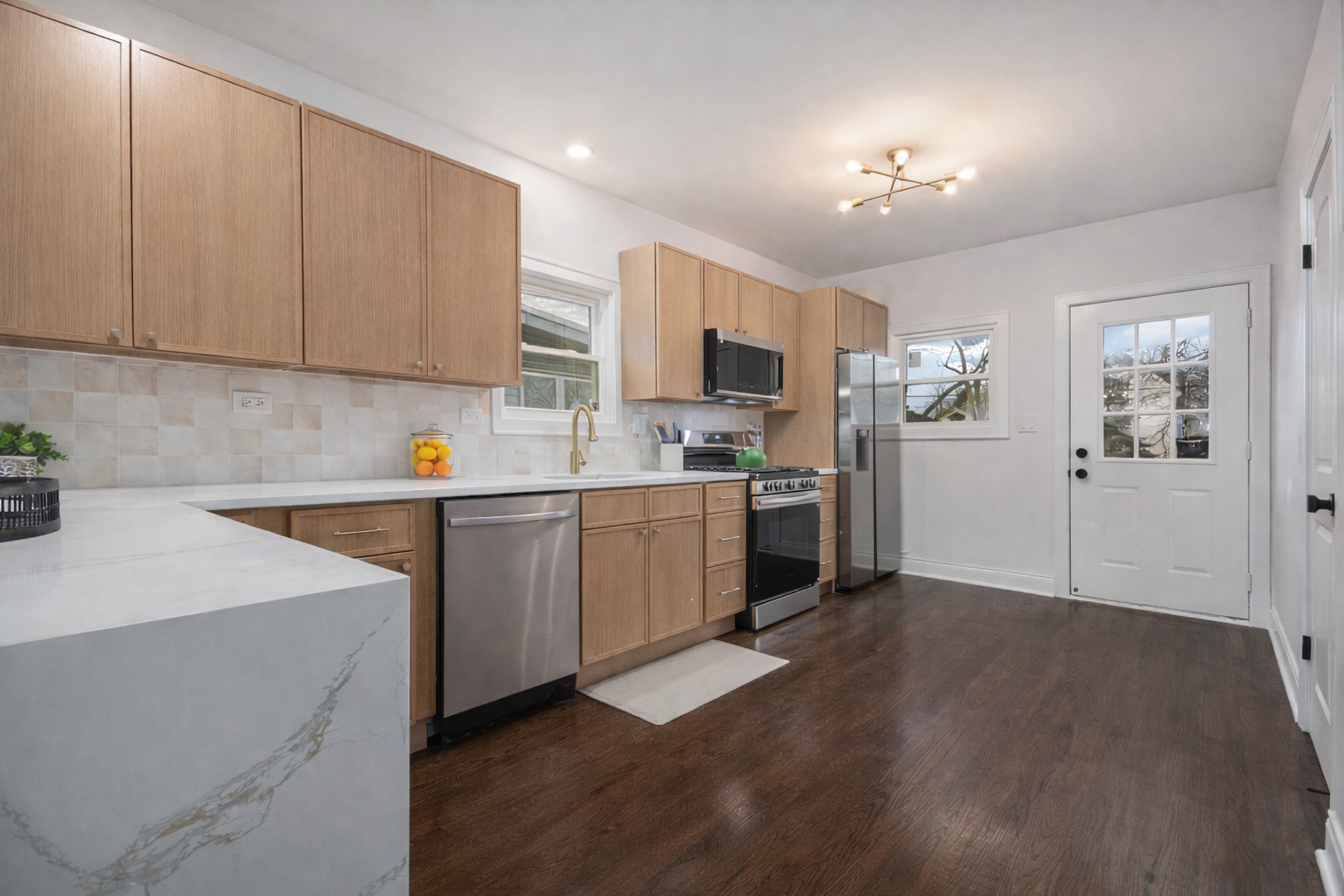 4138 Arthur Avenue Brookfield, IL 60513 - Photo 5 of 25 a kitchen with a sink a refrigerator and cabinets