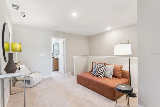 a living room with furniture and a lamp
