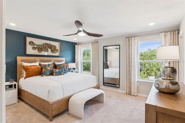 a bedroom with a bed couch and window