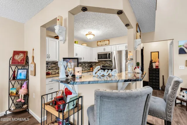 a view of a dining room with furniture and a chandelier