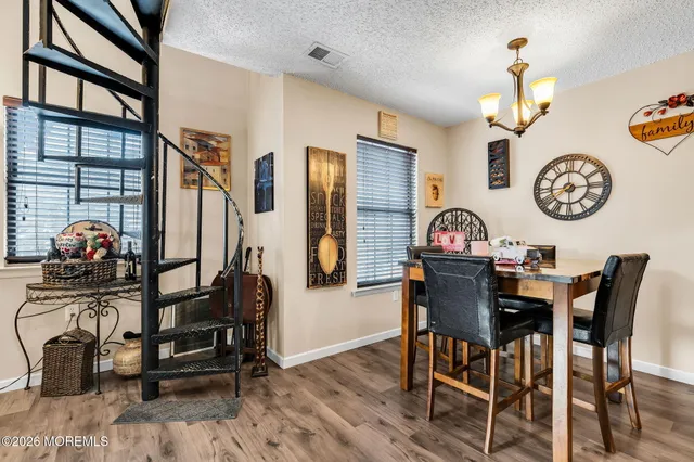 a view of a dining area with furniture and wooden floor