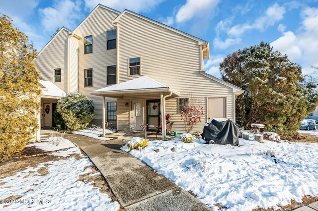 a view of a house with snow on the road