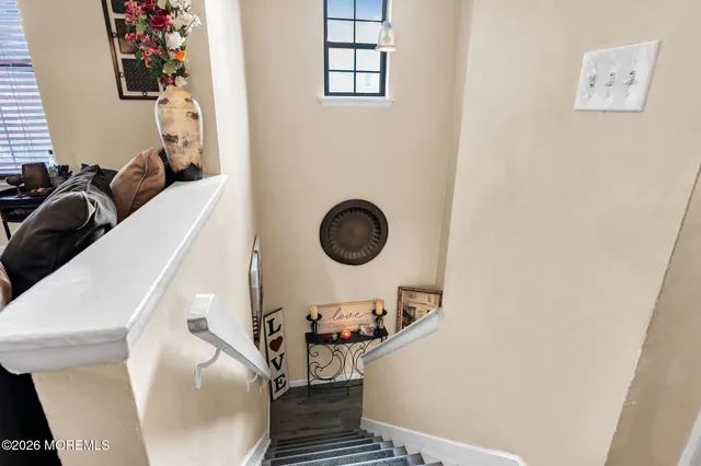 a living room with furniture kitchen view and a chandelier