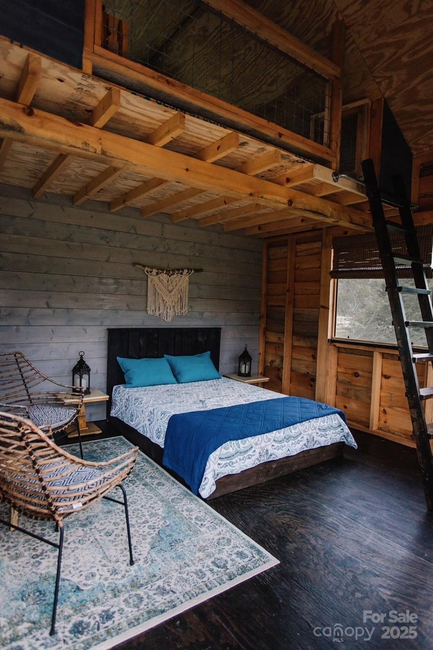 1295 Paint Rock Road Hot Springs, NC 28743 - Photo 11 of 29 a bedroom with a bed a chair and the view of the kitchen