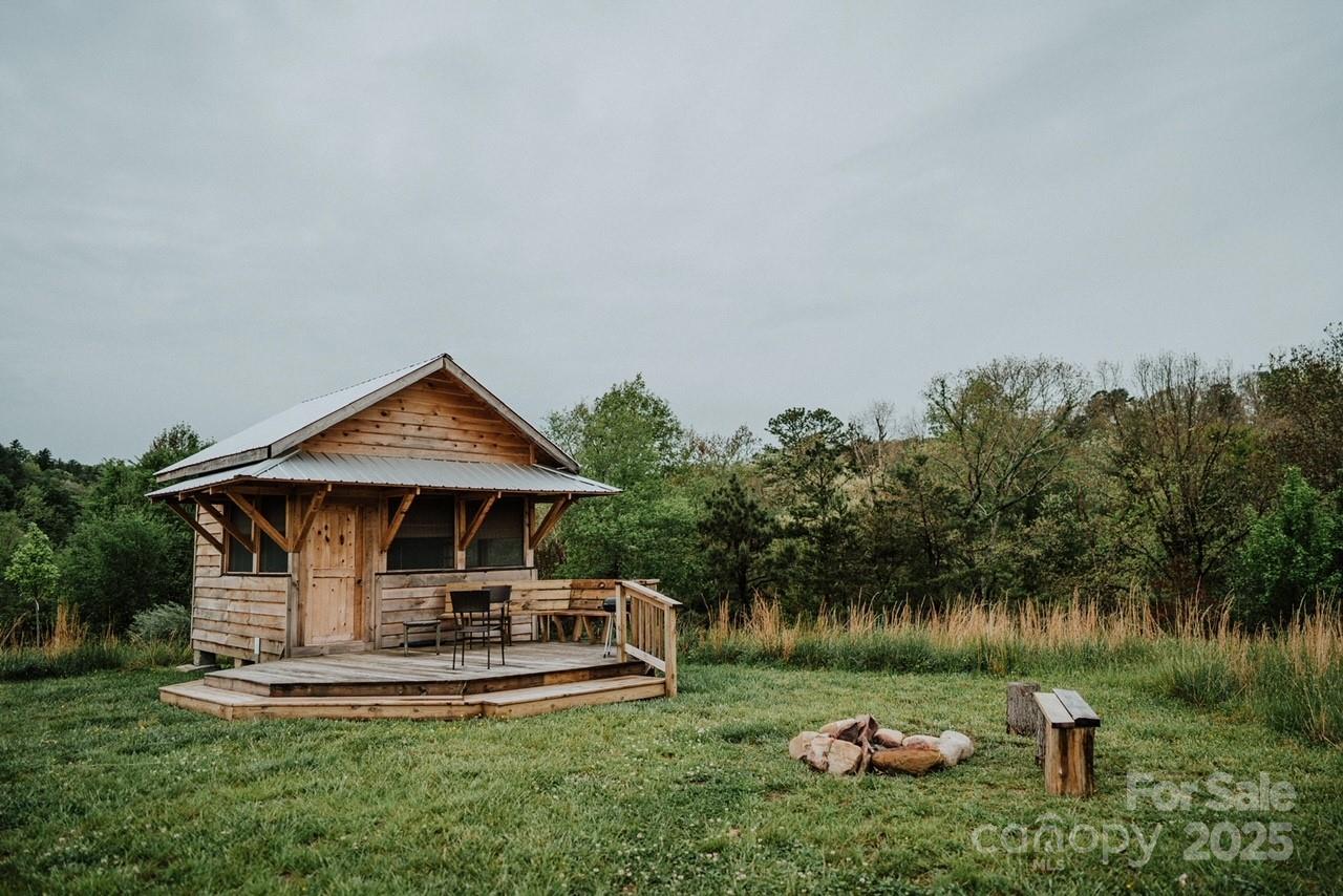 1295 Paint Rock Road Hot Springs, NC 28743 - Photo 17 of 29 a front view of a house with a yard table and chairs