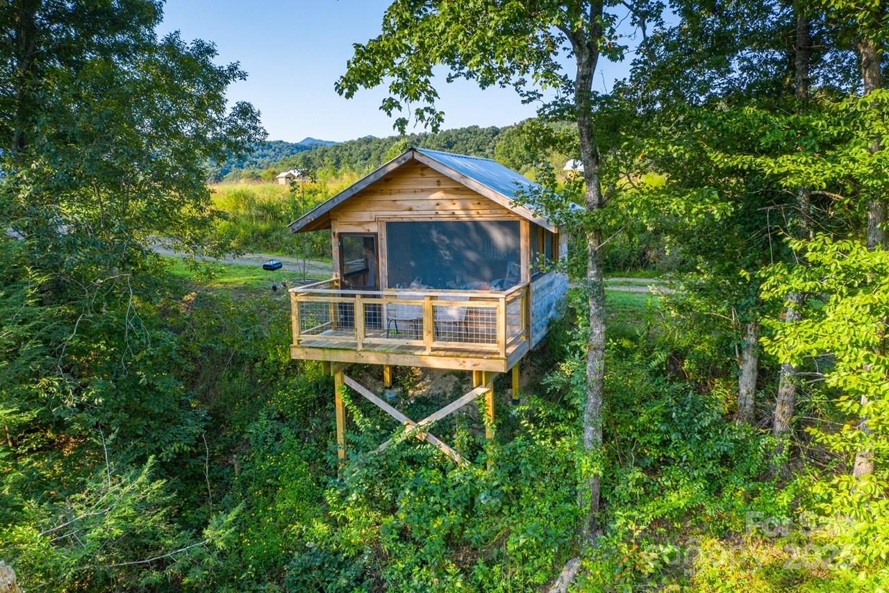 1295 Paint Rock Road Hot Springs, NC 28743 - Photo 4 of 29 a house with trees in the background