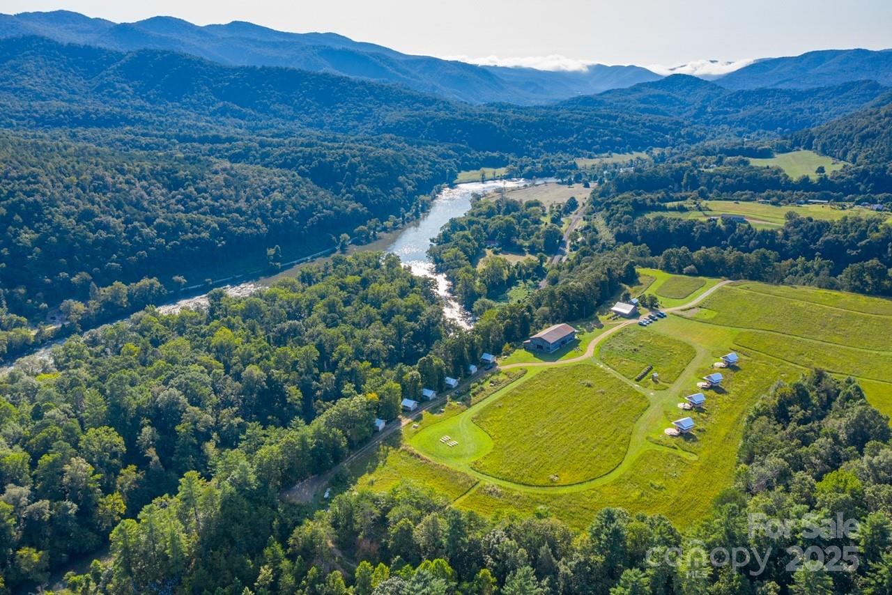 1295 Paint Rock Road Hot Springs, NC 28743 - Photo 6 of 29 a view of a swimming pool with a yard and mountain view