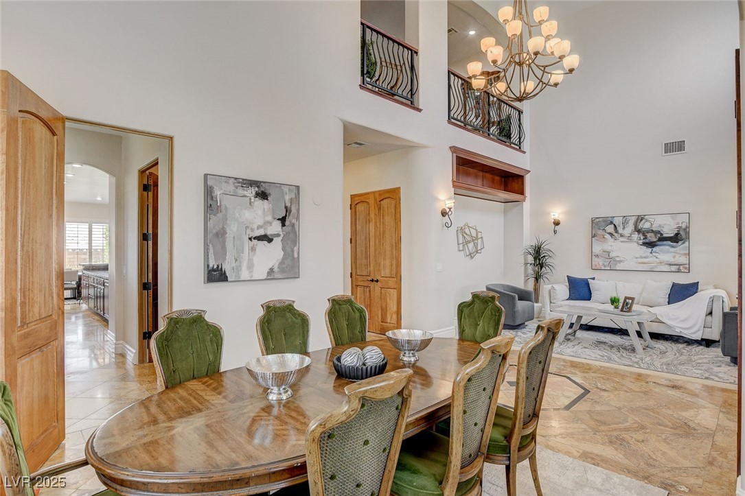 1182 Thomas Bay Circle Logandale, NV 89021 - Photo 11 of 98 Formal dining area featuring a high ceiling and a chandelier and butler pantry