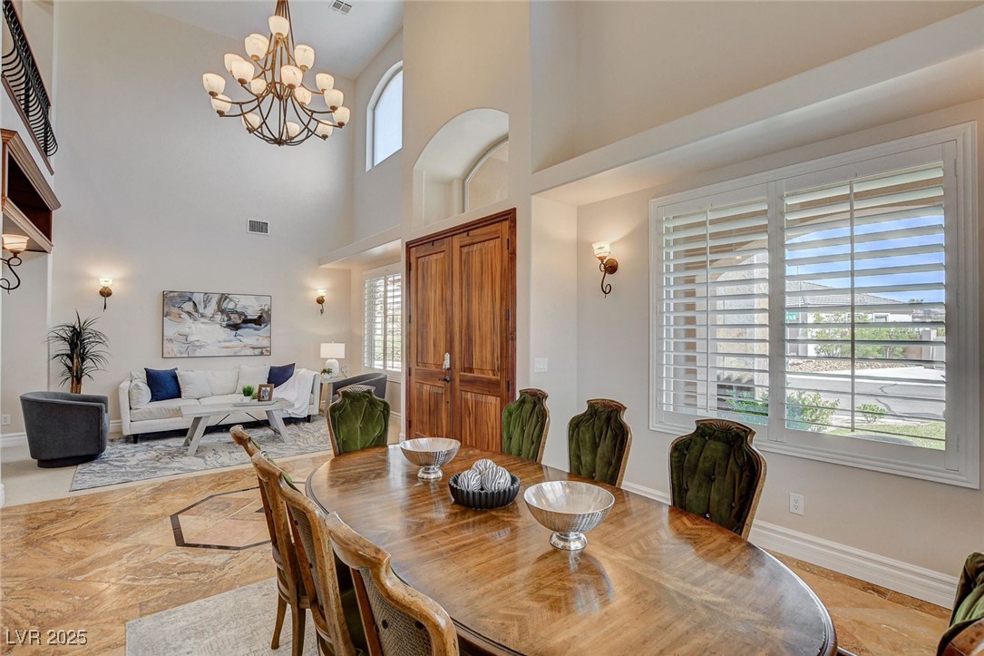 1182 Thomas Bay Circle Logandale, NV 89021 - Photo 12 of 98 Dining room with a chandelier, healthy amount of natural light, and high vaulted ceiling