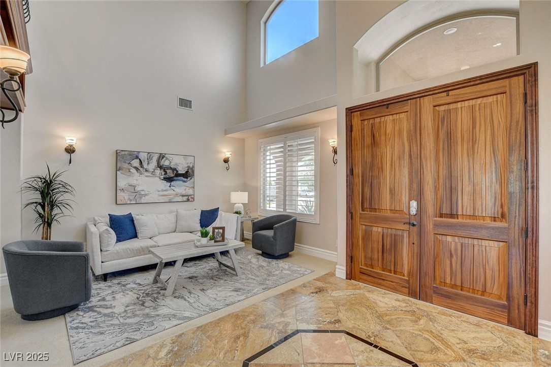 1182 Thomas Bay Circle Logandale, NV 89021 - Photo 13 of 98 Entrance foyer with plenty of natural light, a towering ceiling, and view towards formal living area