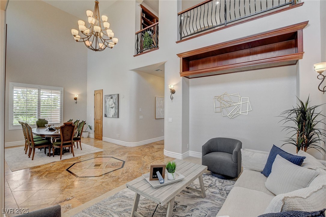 1182 Thomas Bay Circle Logandale, NV 89021 - Photo 18 of 98 Living area with a chandelier, a towering ceiling
