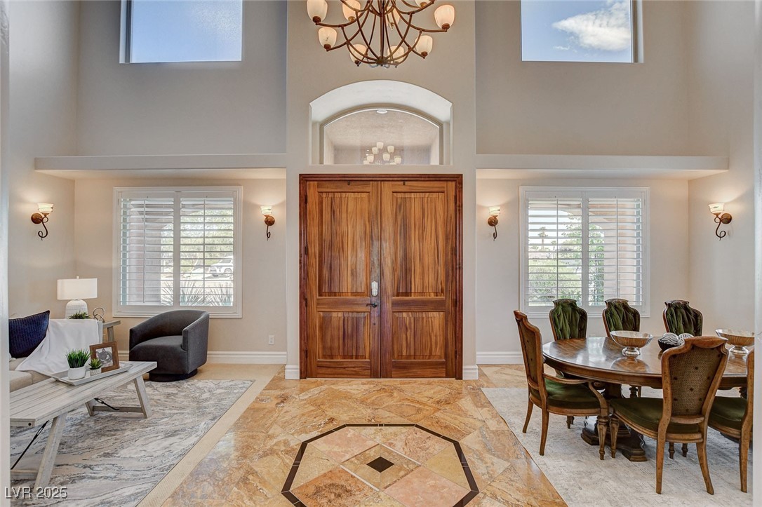 1182 Thomas Bay Circle Logandale, NV 89021 - Photo 2 of 98 Foyer with a high ceiling, a chandelier, and tile flooring