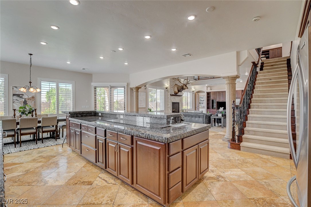 1182 Thomas Bay Circle Logandale, NV 89021 - Photo 26 of 98 Kitchen with recessed lighting, a chandelier, arched walkways, decorative columns, and a center island