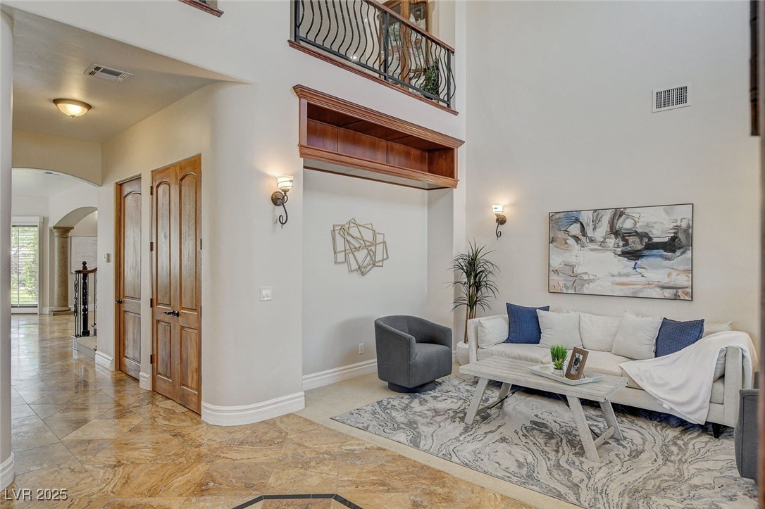 1182 Thomas Bay Circle Logandale, NV 89021 - Photo 3 of 98 Formal living area with view towards additional storage closets and hallway towards kitchen and family area