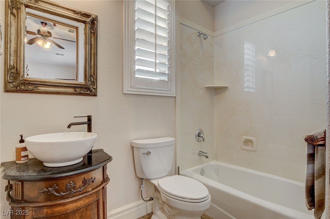 1182 Thomas Bay Circle Logandale, NV 89021 - Photo 47 of 98 Bathroom with shower / tub combination, vanity, and a ceiling fan