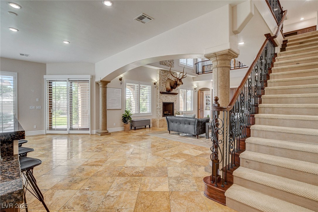 1182 Thomas Bay Circle Logandale, NV 89021 - Photo 49 of 98 Entryway with arched walkways, stairs, a large fireplace, and recessed lighting