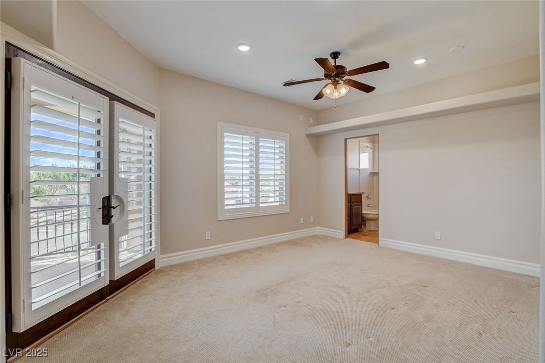 1182 Thomas Bay Circle Logandale, NV 89021 - Photo 54 of 98 Bedroom with balcony access, gorgeous views, carpet flooring, plenty of natural light, a ceiling fan, a smoke detector, and recessed lighting