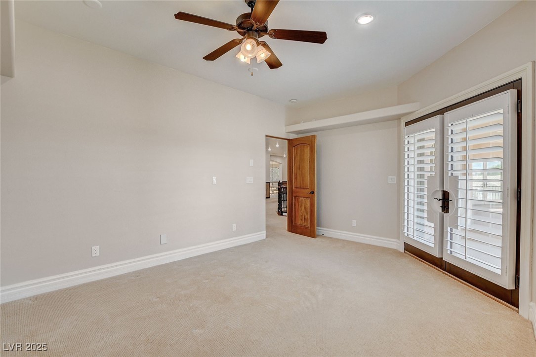 1182 Thomas Bay Circle Logandale, NV 89021 - Photo 55 of 98 Bedroom with balcony access, gorgeous views, carpet flooring, plenty of natural light, a ceiling fan, a smoke detector, and recessed lighting