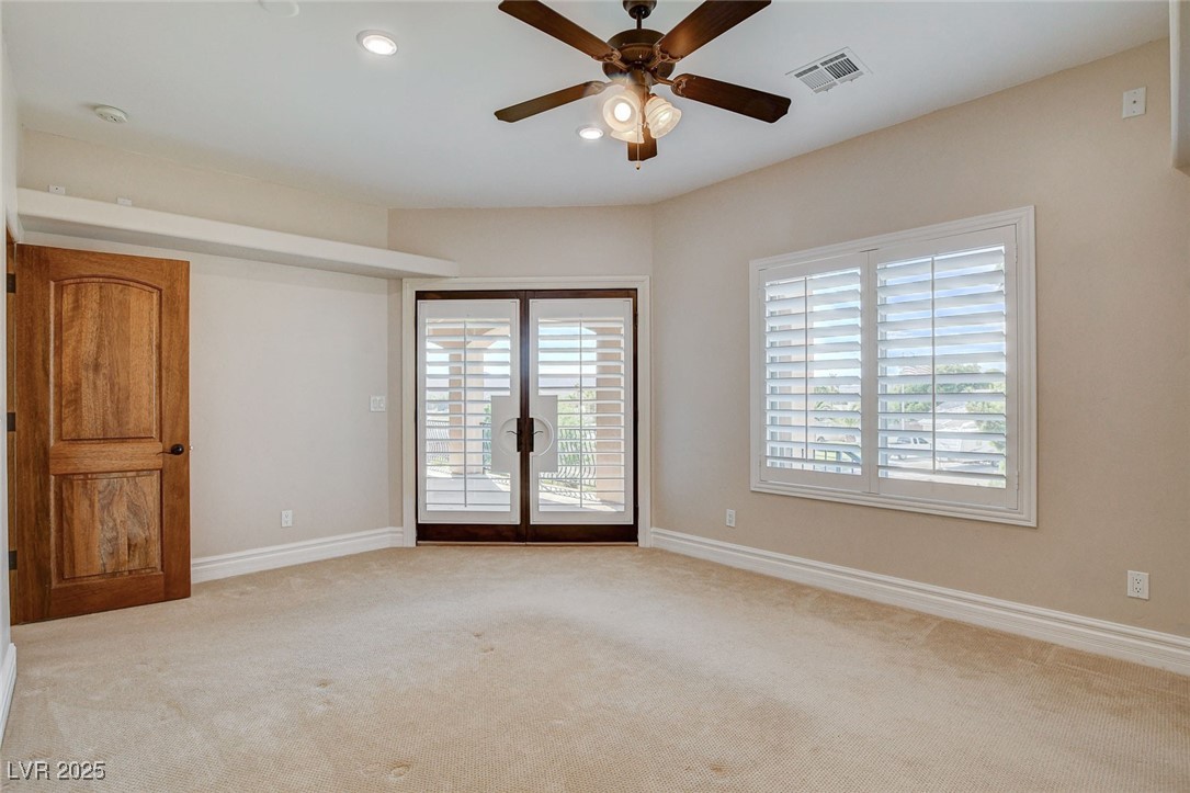 1182 Thomas Bay Circle Logandale, NV 89021 - Photo 56 of 98 Bedroom with balcony access, gorgeous views, carpet flooring, plenty of natural light, a ceiling fan, a smoke detector, and recessed lighting