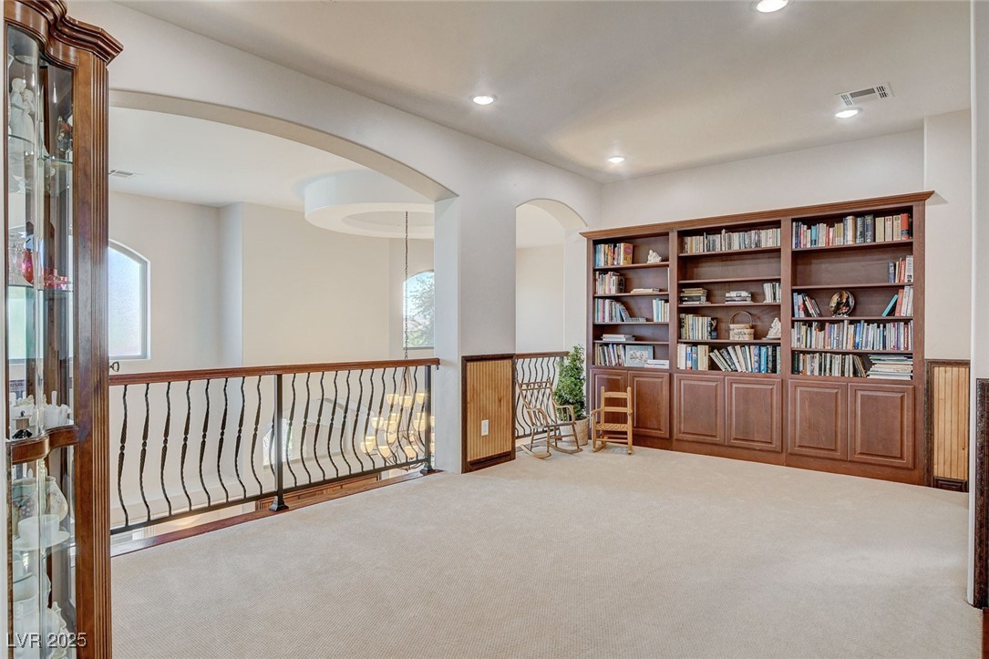 1182 Thomas Bay Circle Logandale, NV 89021 - Photo 61 of 98 Loft off primary bedroom featuring carpet, arched walkways, and recessed lighting