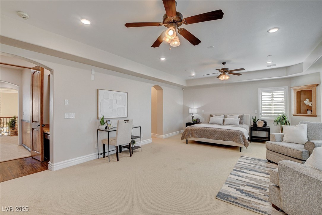 1182 Thomas Bay Circle Logandale, NV 89021 - Photo 65 of 98 Primary bedroom with arched walkways, carpet floors, recessed lighting, and a ceiling fan