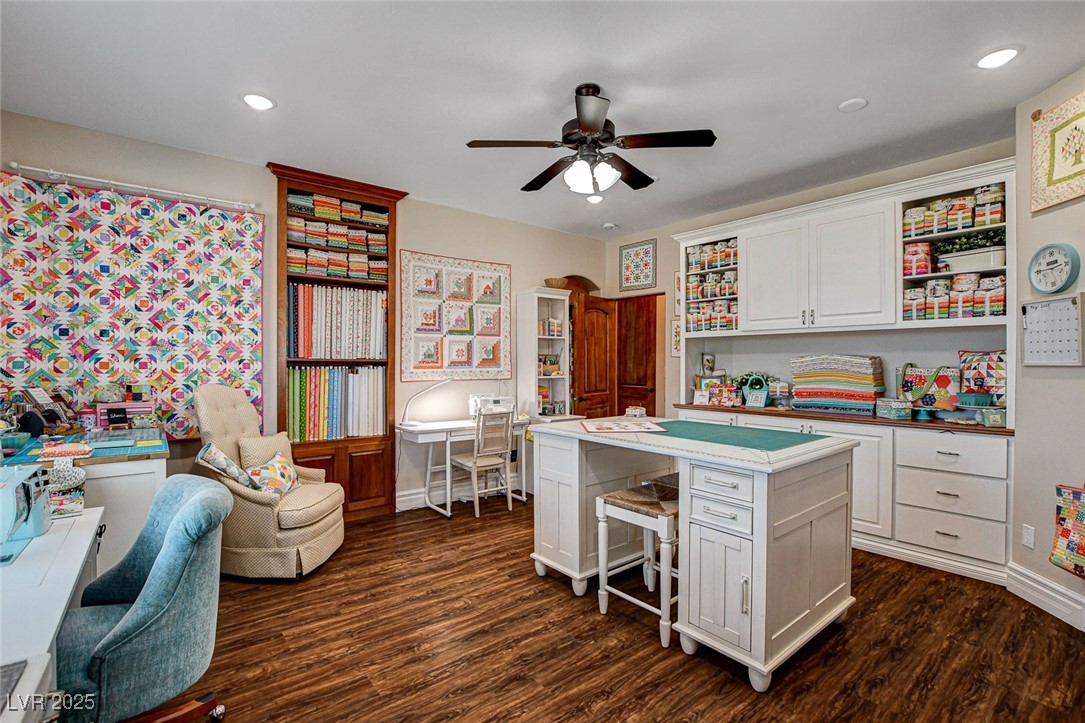 1182 Thomas Bay Circle Logandale, NV 89021 - Photo 79 of 98 Office space, craft room or bedroom with walk in closet featuring dark wood-style flooring, built in desk, ceiling fan, and recessed lighting