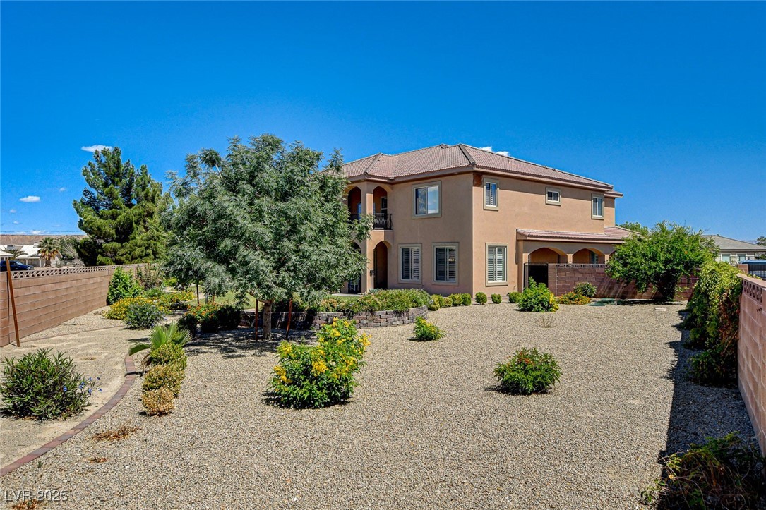 1182 Thomas Bay Circle Logandale, NV 89021 - Photo 90 of 98 Rear view of house with stucco siding and a fenced backyard