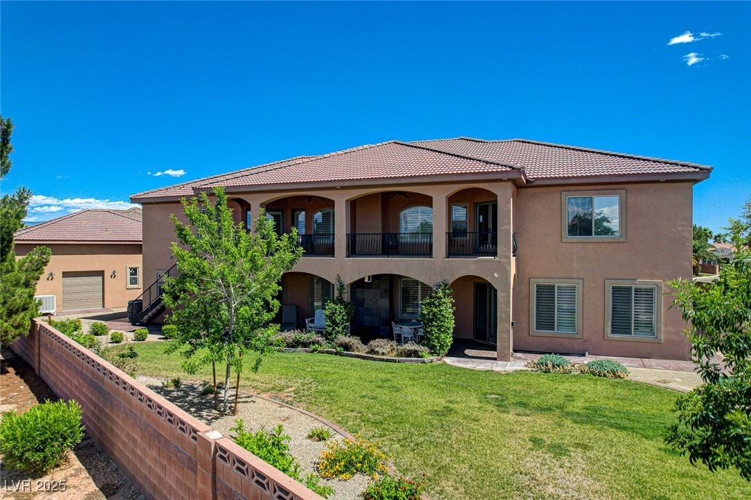1182 Thomas Bay Circle Logandale, NV 89021 - Photo 92 of 98 Stucco siding, a balcony, a tiled roof, and a detached RV garage