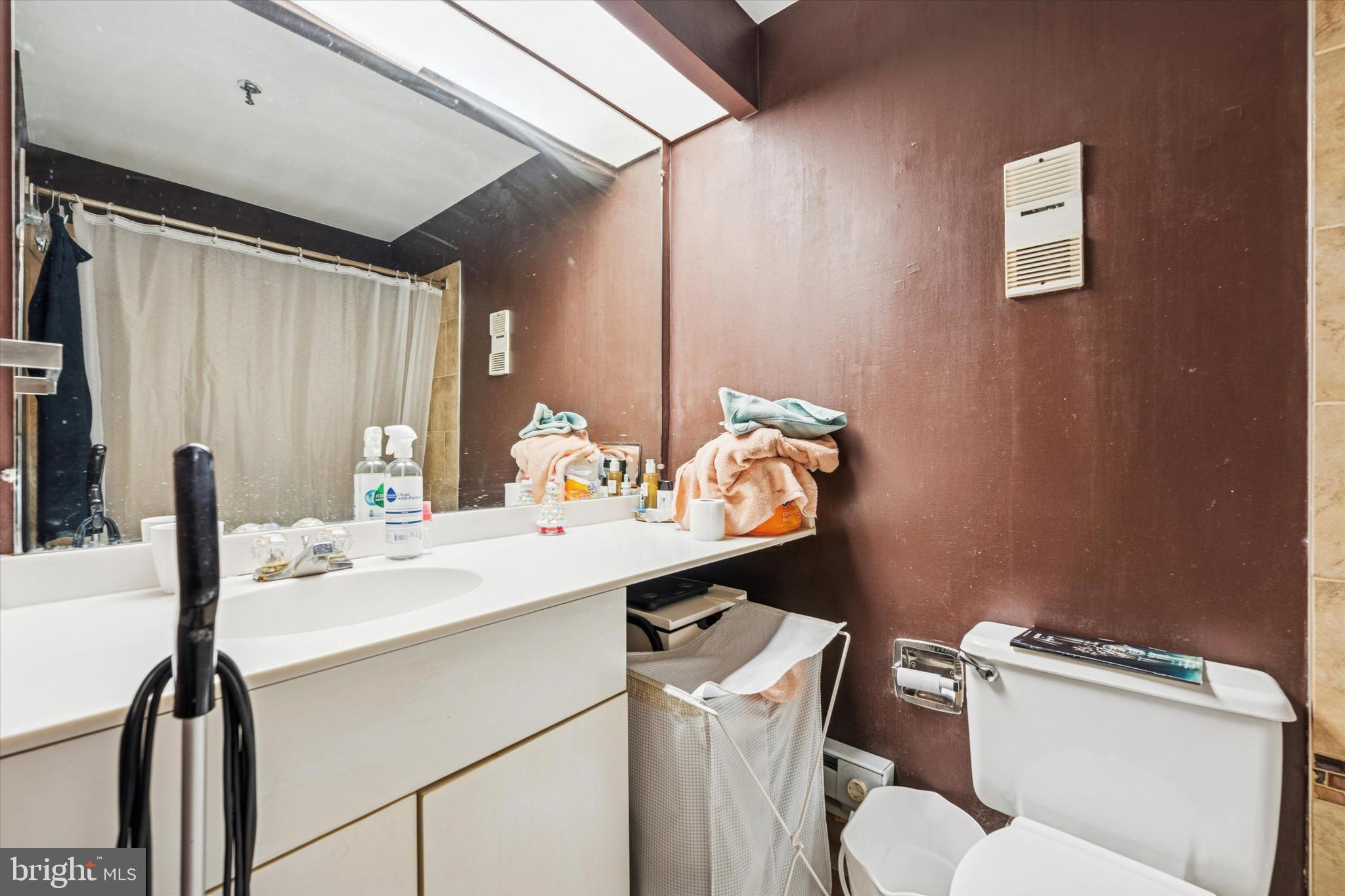 1010 Race Street, Unit PHM Philadelphia, PA 19107 - Photo 13 of 14 a bathroom with a sink mirror vanity and toilet