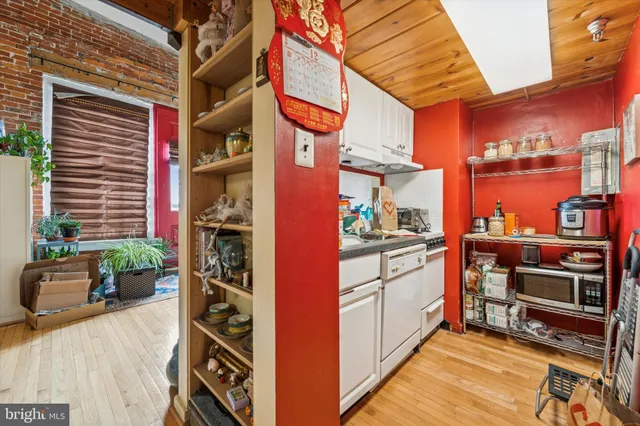 a view of a kitchen with furniture and a potted plant