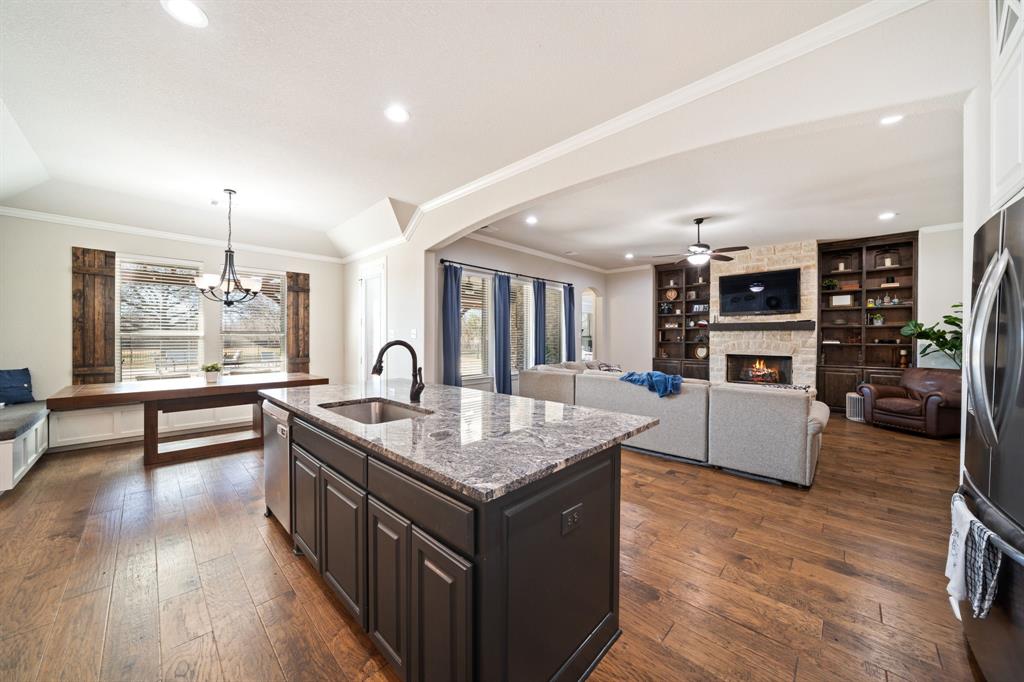 3601 Plainview Road Midlothian, TX 76065 - Photo 14 of 40 a kitchen with granite countertop a stove and a wooden floors