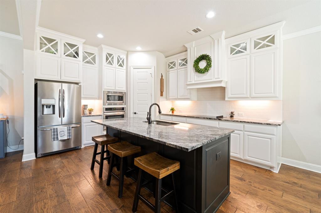 3601 Plainview Road Midlothian, TX 76065 - Photo 16 of 40 a kitchen with granite countertop a sink appliances a counter space and cabinets