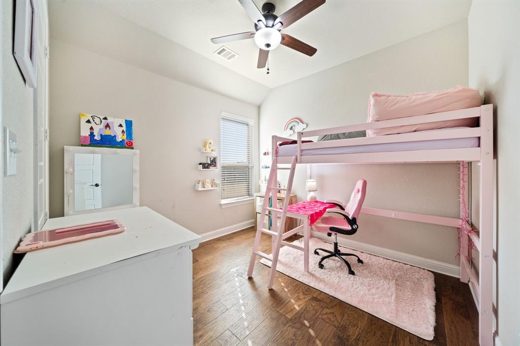 3601 Plainview Road Midlothian, TX 76065 - Photo 28 of 40 a bedroom with a bed and a chandelier