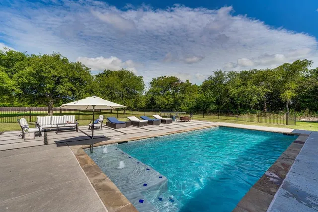 a view of a swimming pool with a patio