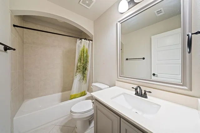 a view of a hallway view with wooden floor and a kitchen