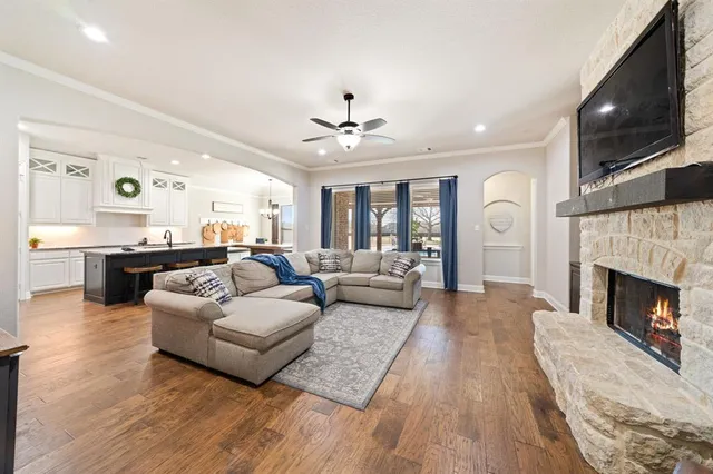 a living room with furniture and view of kitchen