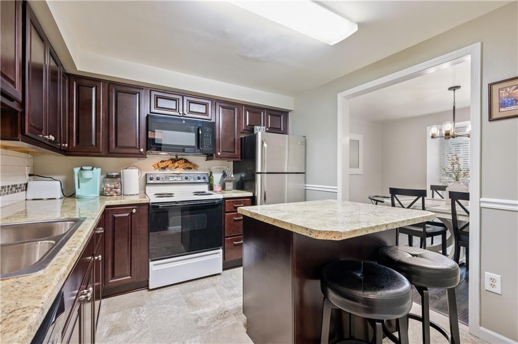 501 Cherry Court Pittsburgh, PA 15237 - Photo 7 of 25 a kitchen with a stove a sink and a refrigerator