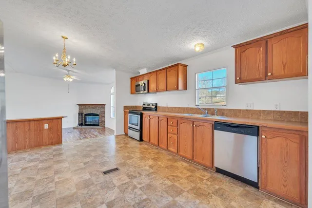 a view of a kitchen with a sink and a stove top oven