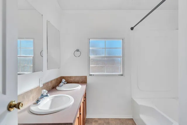 a view of a dining room with furniture a chandelier and wooden floor