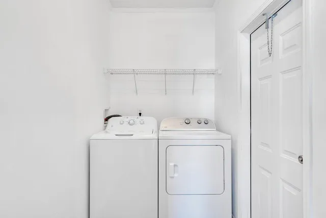 a view of a room with wooden floor and window