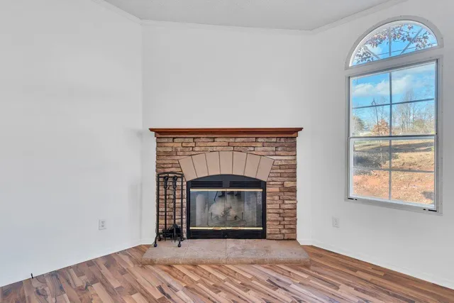 a view of a kitchen with a sink and dishwasher a refrigerator with wooden floor