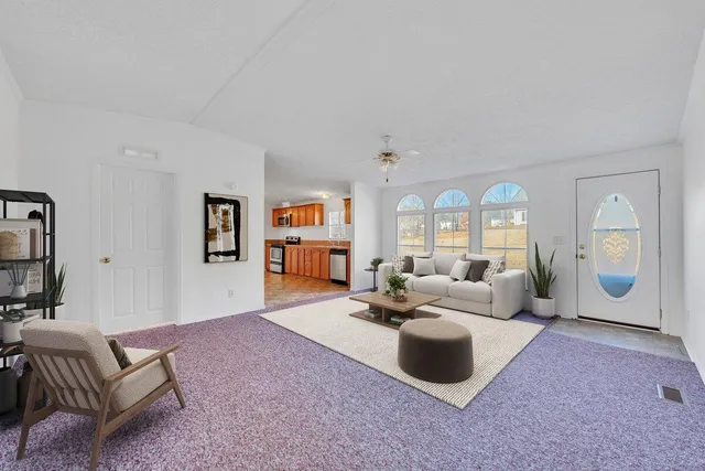 a large kitchen with stainless steel appliances kitchen island granite countertop a refrigerator and a stove top oven