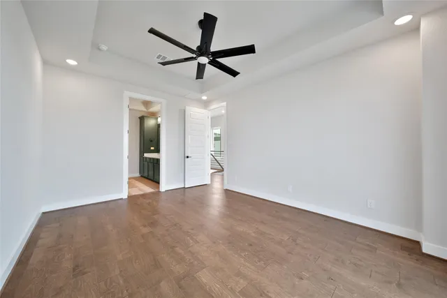 a view of a big room with wooden floor and windows in a room