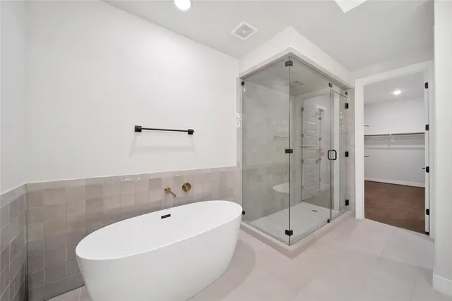 a bathroom with a tub and shower