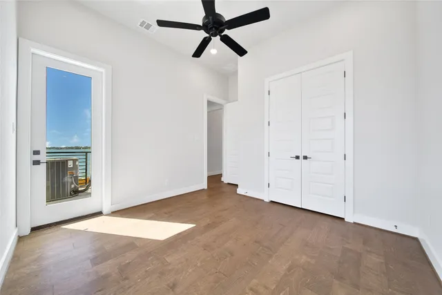 a view of an empty room with a ceiling fan