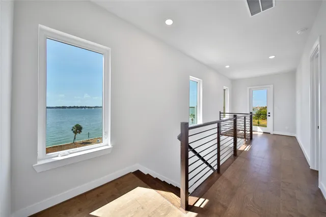 a view of a hallway with furniture and window