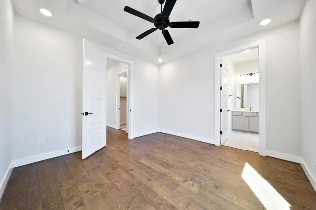 a view of an empty room and window and a ceiling fan