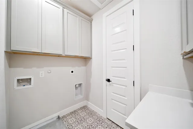 a view of a livingroom with a chandelier fan and a fireplace