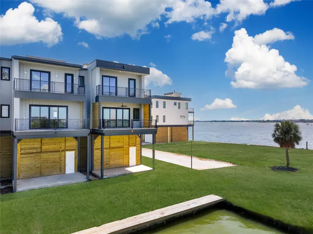 a swimming pool with outdoor seating and yard